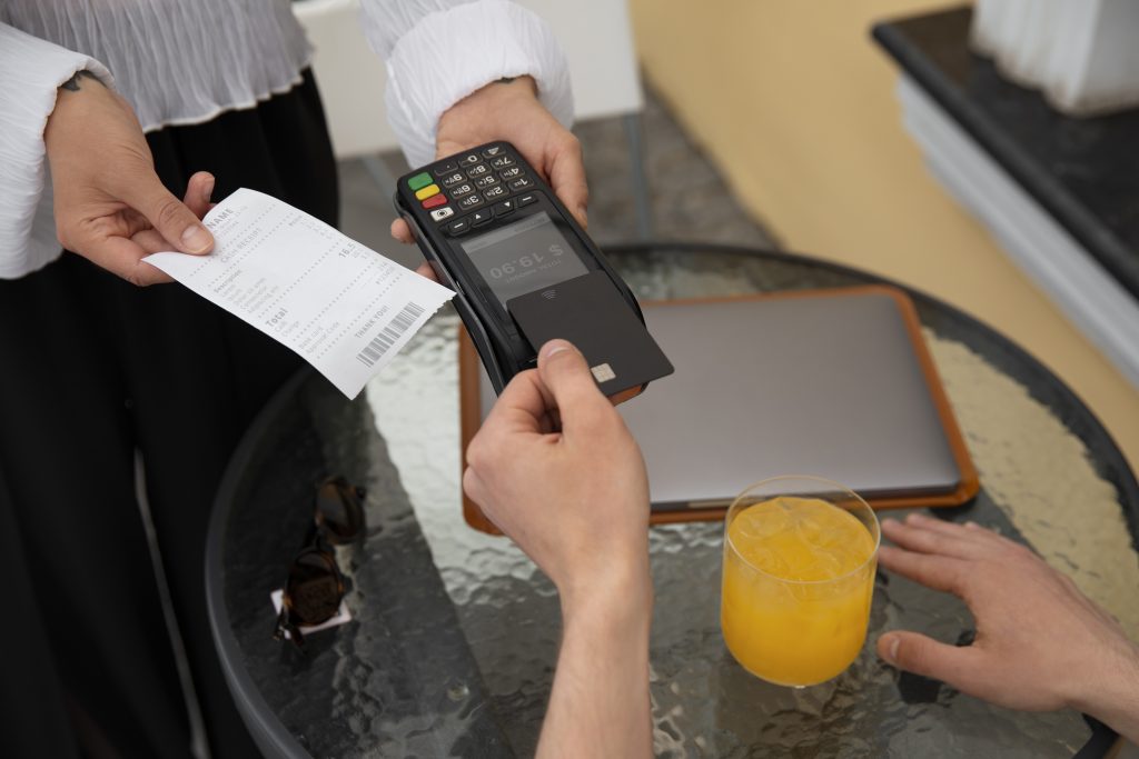 high angle customer paying with nfc device